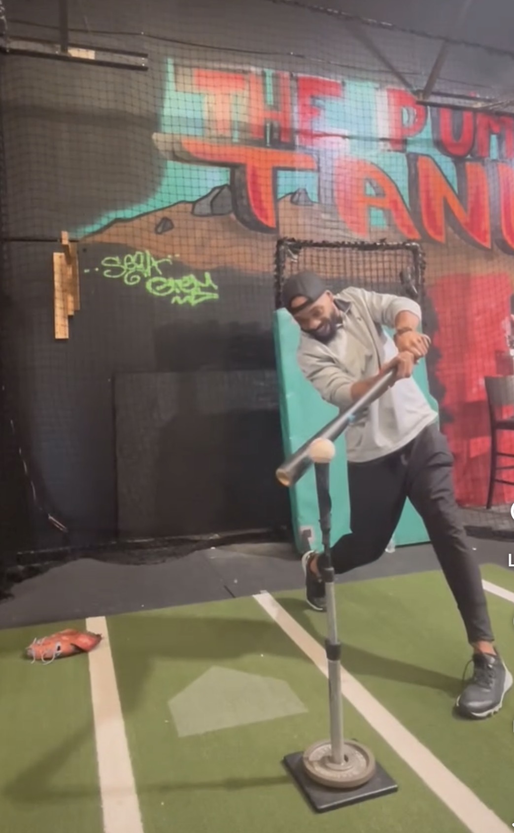 Coach Corey Stigar — full-force tee swing at The Pump Tank